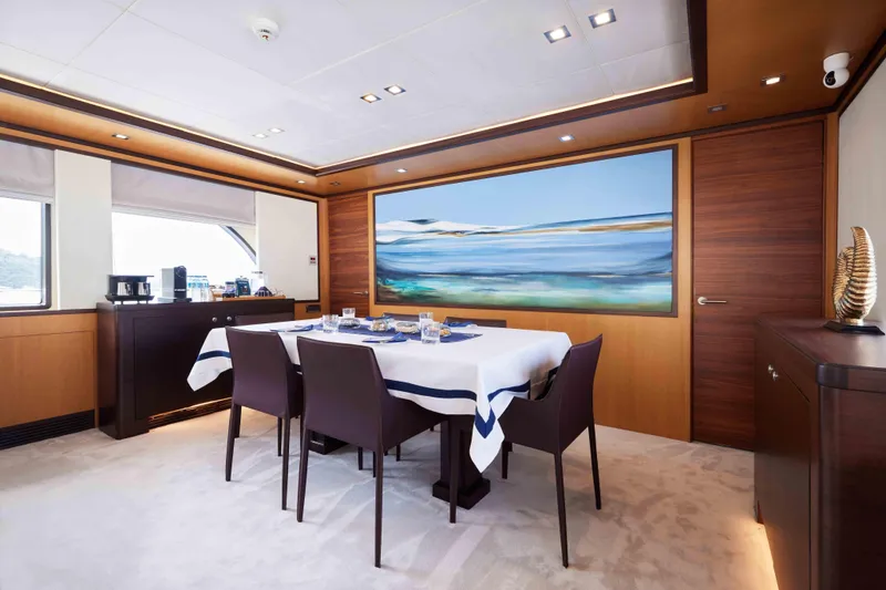 Aysha Yacht Photos Pics Luxurious dining area on 2012 Timmerman 26 yacht with elegant decor and large seascape painting.