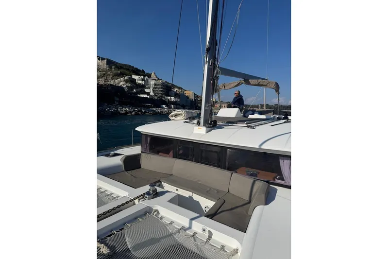 Honu Yacht Photos Pics 2015 Lagoon 450 F catamaran with scenic coastal backdrop and clear blue sky.