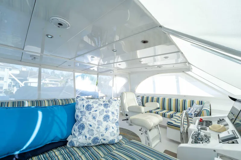 Sea Dreamz Yacht Photos Pics Luxurious interior of 2016 Horizon PC52 yacht with striped seating and nautical decor.