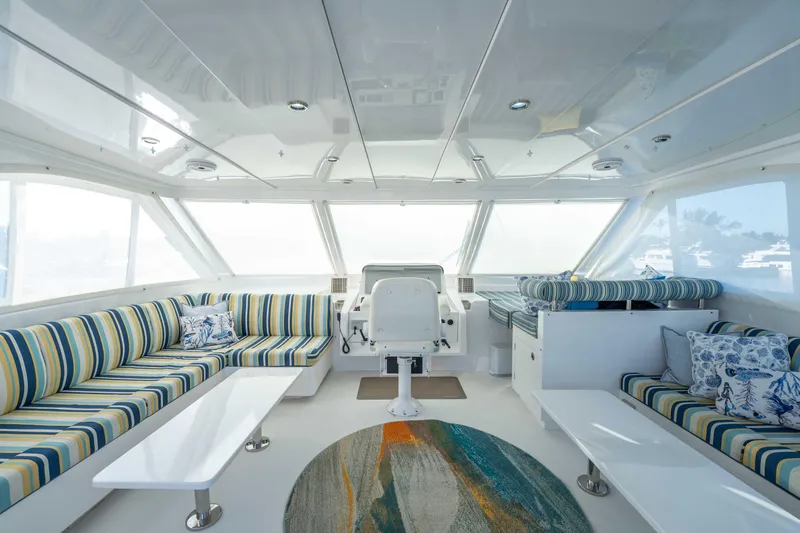 Sea Dreamz Yacht Photos Pics Luxurious interior of 2016 Horizon PC52 yacht with striped seating and modern decor.