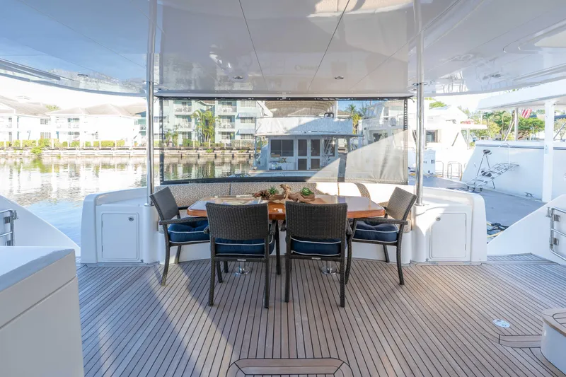 Sea Dreamz Yacht Photos Pics Luxurious 2016 Horizon PC52 yacht deck with elegant dining area and waterfront view.