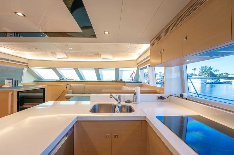 Sea Dreamz Yacht Photos Pics Luxurious interior of 2016 Horizon PC52 yacht with modern kitchen and scenic window views.