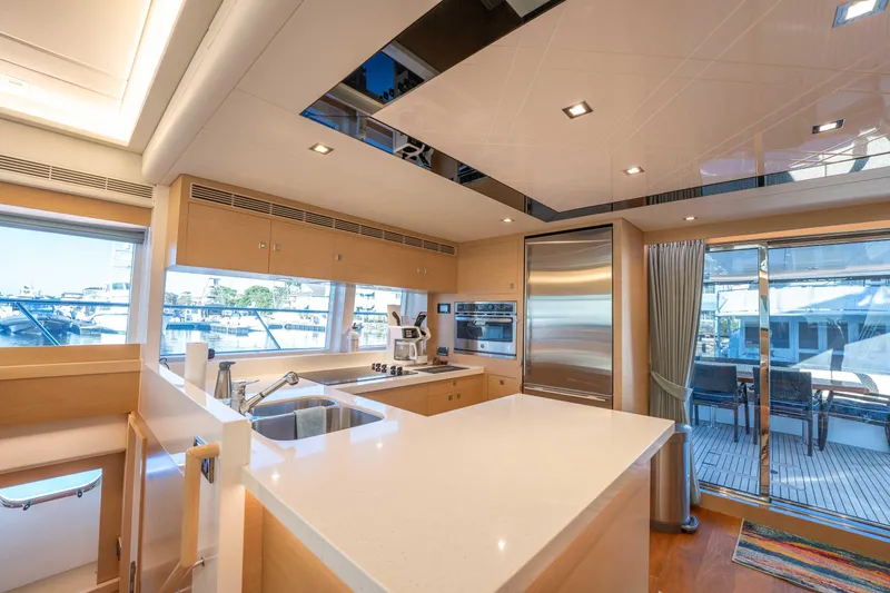 Sea Dreamz Yacht Photos Pics Luxurious kitchen interior of 2016 Horizon PC52 yacht with modern appliances and sleek design.