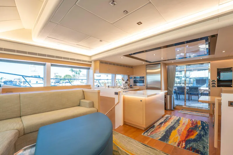 Sea Dreamz Yacht Photos Pics Luxurious interior of 2016 Horizon PC52 yacht with modern kitchen and seating area.