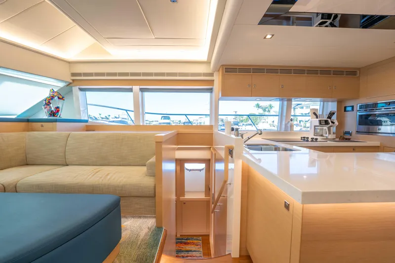 Sea Dreamz Yacht Photos Pics Luxurious interior of 2016 Horizon PC52 yacht with modern kitchen and seating area.
