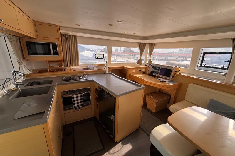 Honu Yacht Photos Pics Interior of 2016 Lagoon 450 F catamaran with modern kitchen and navigation area.