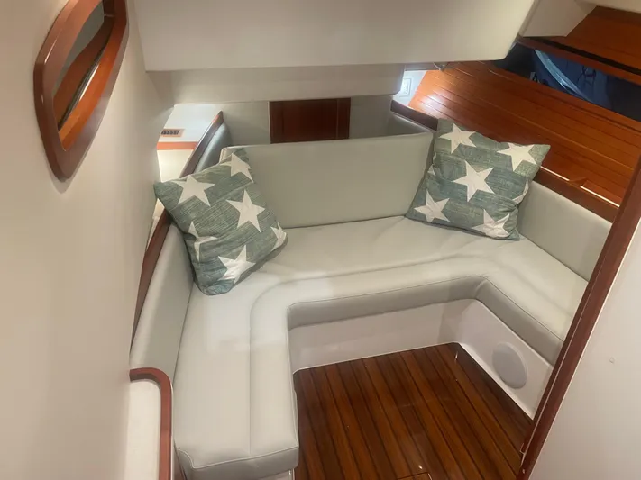 Artemis Yacht Photos Pics 2023 MJM 4 boat interior with star-patterned cushions and wooden flooring.