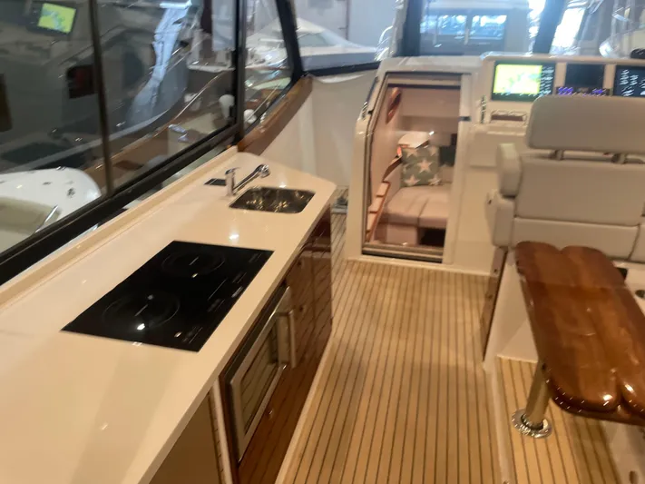 Artemis Yacht Photos Pics Modern MJM 4 yacht interior with kitchenette, seating, and navigation area, 2023 model.