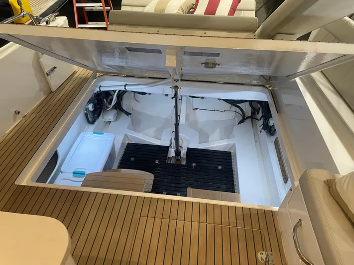 Artemis Yacht Photos Pics 2023 MJM 4 boat engine compartment with open hatch, showcasing interior components and teak flooring.