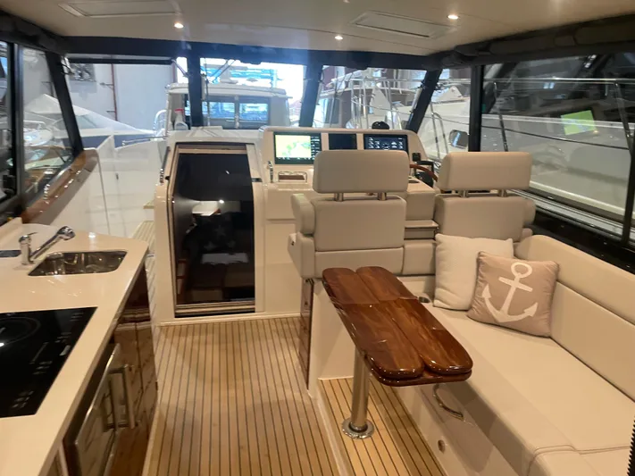 Artemis Yacht Photos Pics Luxurious interior of 2023 MJM 4 yacht with modern seating and navigation equipment.