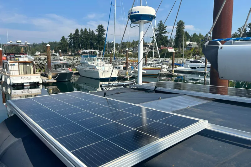 Summer Solace Yacht Photos Pics Jeanneau Sun Odyssey 40 sailboat with solar panels docked in a marina, 2000 model.