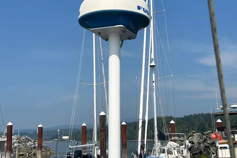 Summer Solace Yacht Photos Pics Jeanneau Sun Odyssey 40 sailboat docked, featuring radar equipment, clear sky, and marina backdrop.