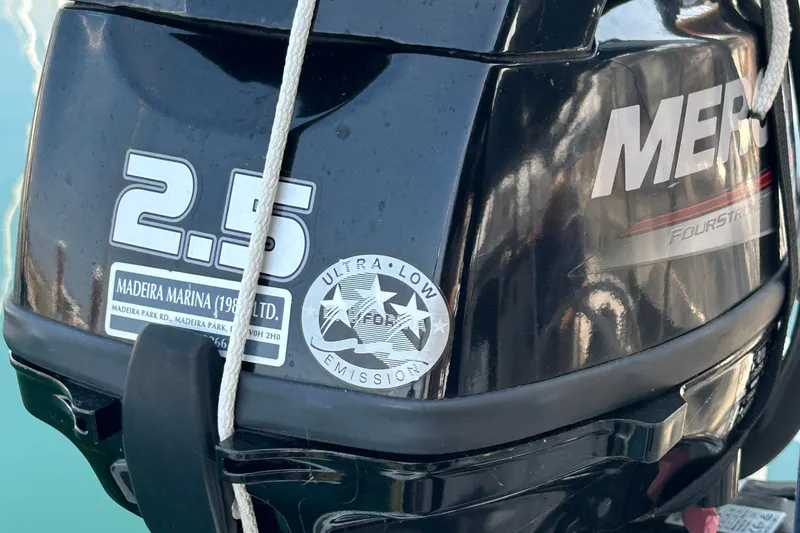 Summer Solace Yacht Photos Pics Close-up of a 2.5 HP Mercury outboard motor with ultra-low emission label.