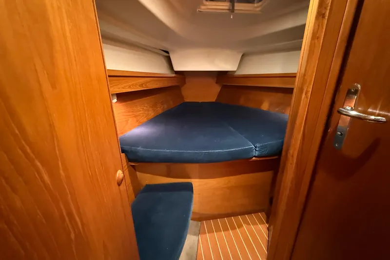 Summer Solace Yacht Photos Pics Cozy cabin interior of 2000 Jeanneau Sun Odyssey 40 sailboat with blue cushions.
