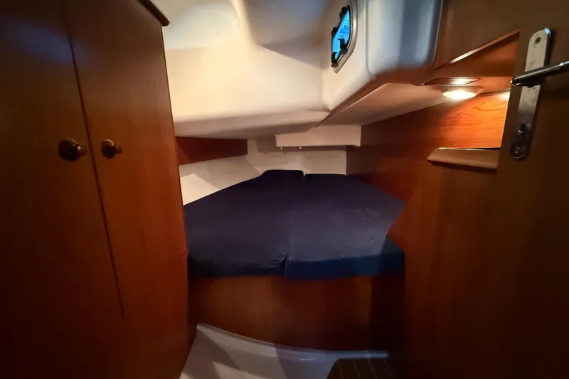 Summer Solace Yacht Photos Pics Cozy cabin interior of 2000 Jeanneau Sun Odyssey 40 sailboat with wooden furnishings.
