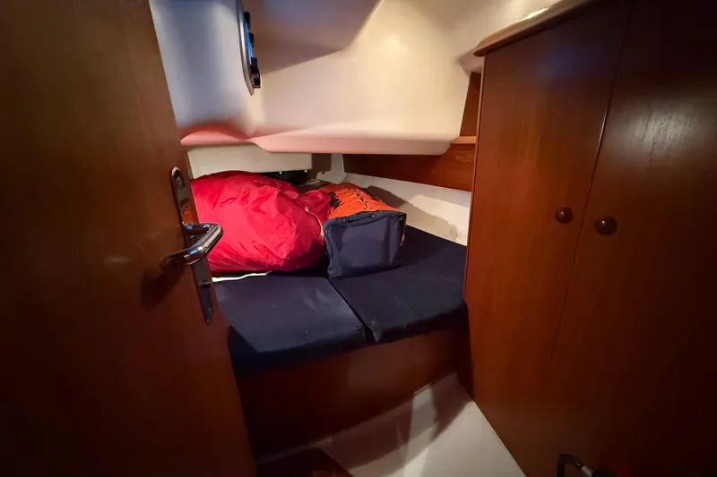 Summer Solace Yacht Photos Pics Cozy cabin interior of 2000 Jeanneau Sun Odyssey 40 sailboat with storage and bedding.