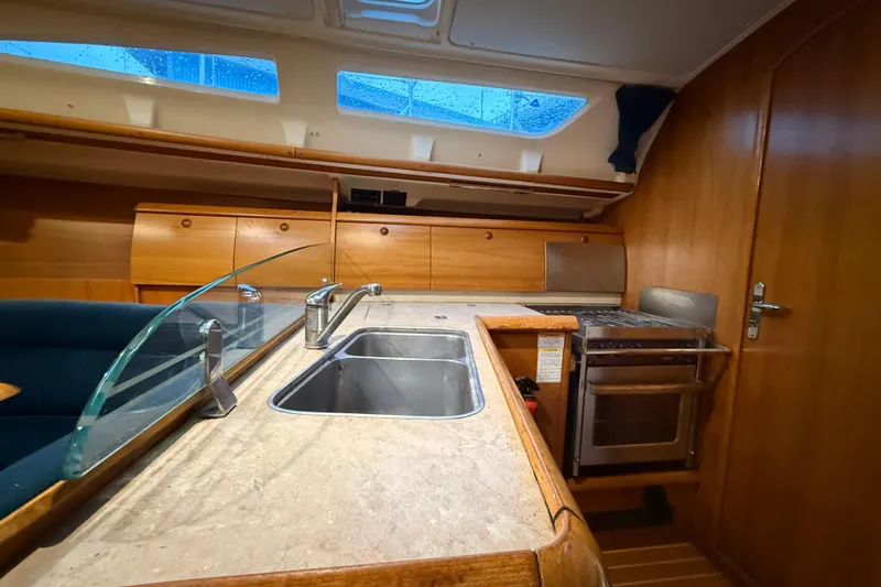 Summer Solace Yacht Photos Pics Interior of 2000 Jeanneau Sun Odyssey 40 yacht kitchen with sink and stove.