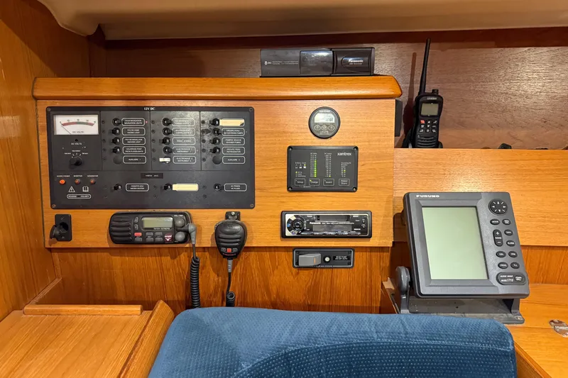 Summer Solace Yacht Photos Pics Control panel of a 2000 Jeanneau Sun Odyssey 40 sailboat with navigation equipment.
