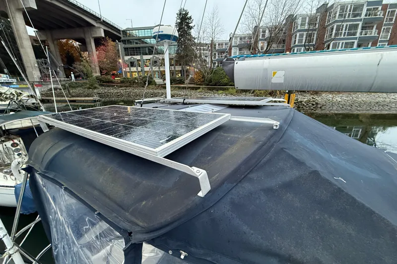 Summer Solace Yacht Photos Pics Solar panels on Jeanneau Sun Odyssey 40 sailboat, docked near urban buildings, 2000 model.