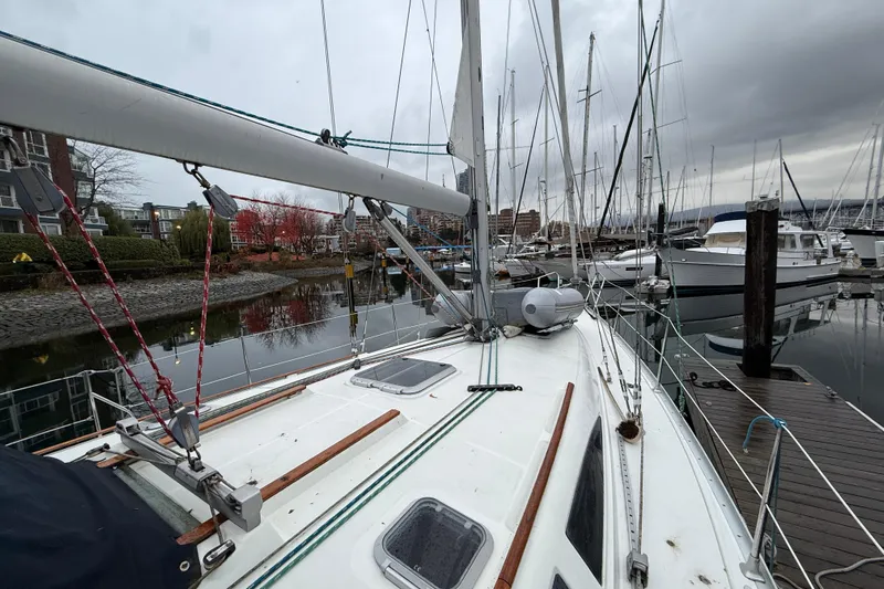 Summer Solace Yacht Photos Pics Jeanneau Sun Odyssey 40 sailboat docked in a marina, overcast sky, 2000 model.