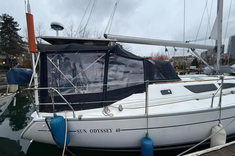Summer Solace Yacht Photos Pics Jeanneau Sun Odyssey 40 sailboat, 2000 model, docked with protective cover.