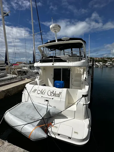  Yacht Photos Pics 2006 Silverton 43 Sport Bridge yacht docked at marina under blue sky.
