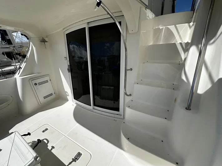  Yacht Photos Pics 2006 Silverton 43 Sport Bridge yacht interior with stairs and sliding glass door.