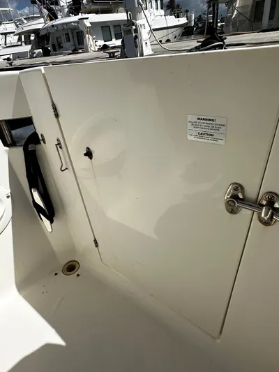  Yacht Photos Pics 2006 Silverton 43 Sport Bridge boat deck with storage compartment and safety warning label.