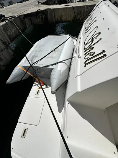  Yacht Photos Pics 2006 Silverton 43 Sport Bridge docked with inflatable boat attached.