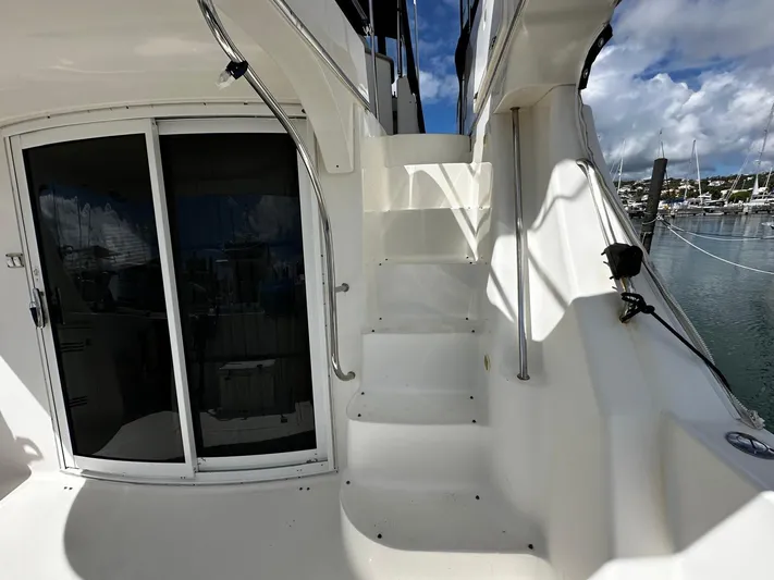  Yacht Photos Pics Staircase on 2006 Silverton 43 Sport Bridge yacht, leading to upper deck, with marina view.