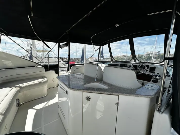  Yacht Photos Pics 2006 Silverton 43 Sport Bridge yacht interior with helm, seating, and kitchenette.