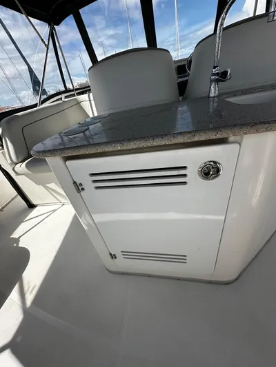  Yacht Photos Pics 2006 Silverton 43 Sport Bridge interior with seating and storage cabinet.