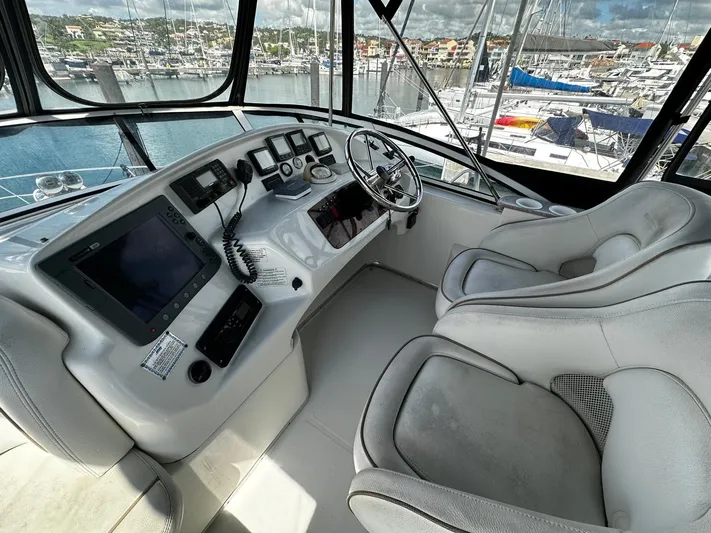  Yacht Photos Pics 2006 Silverton 43 Sport Bridge helm with modern navigation equipment and marina view.