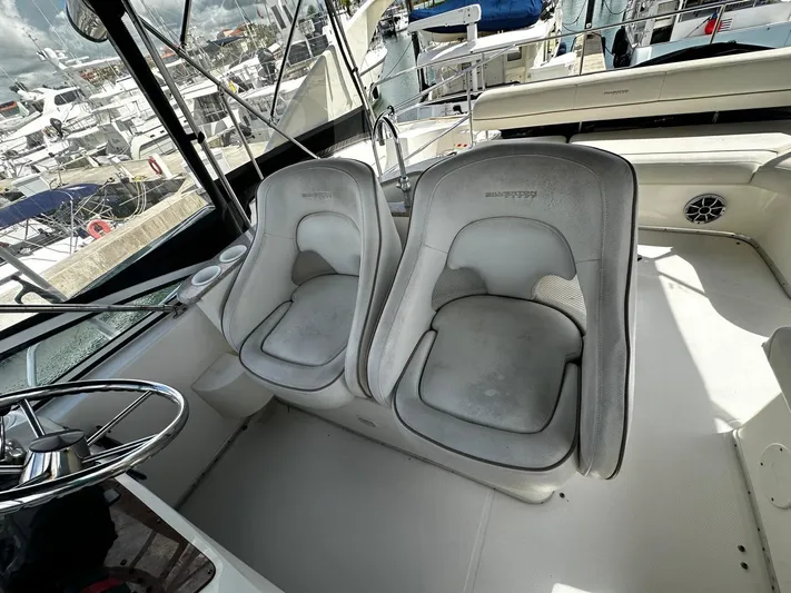  Yacht Photos Pics 2006 Silverton 43 Sport Bridge interior with two helm seats and steering wheel.