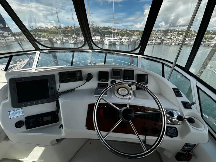  Yacht Photos Pics Helm of 2006 Silverton 43 Sport Bridge yacht with marina view.