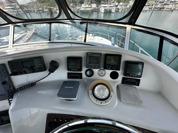  Yacht Photos Pics 2006 Silverton 43 Sport Bridge helm with navigation instruments and marina view.