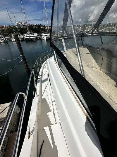  Yacht Photos Pics 2006 Silverton 43 Sport Bridge yacht docked at marina, showcasing sleek design and spacious deck.