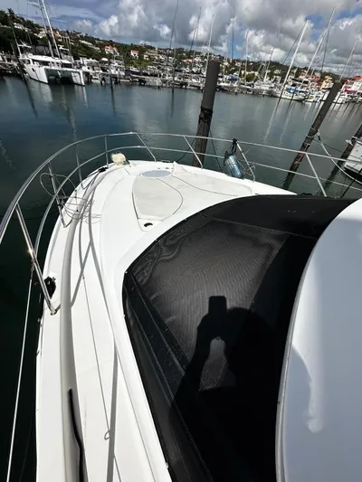  Yacht Photos Pics 2006 Silverton 43 Sport Bridge yacht docked in a marina, with scenic waterfront view.