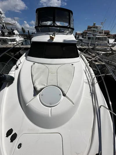  Yacht Photos Pics 2006 Silverton 43 Sport Bridge yacht docked at marina, featuring sleek design and spacious deck.