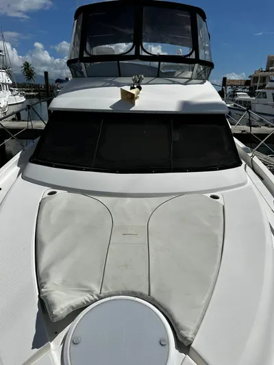  Yacht Photos Pics 2006 Silverton 43 Sport Bridge yacht docked at marina under clear blue sky.