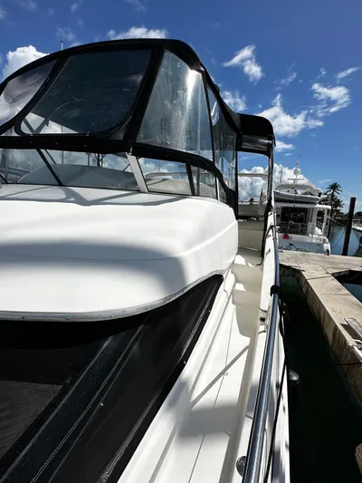  Yacht Photos Pics 2006 Silverton 43 Sport Bridge yacht docked under clear blue sky.