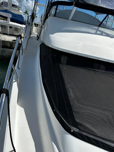  Yacht Photos Pics 2006 Silverton 43 Sport Bridge yacht docked at marina, side view.