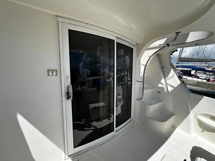  Yacht Photos Pics 2006 Silverton 43 Sport Bridge yacht with sliding glass door and curved interior steps.