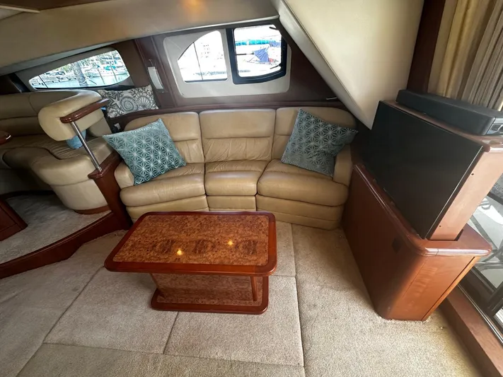  Yacht Photos Pics Interior of 2006 Silverton 43 Sport Bridge with beige leather seating and wooden table.