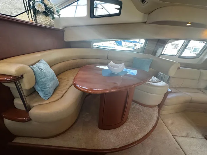  Yacht Photos Pics Luxurious interior of a 2006 Silverton 43 Sport Bridge yacht with elegant seating and table.