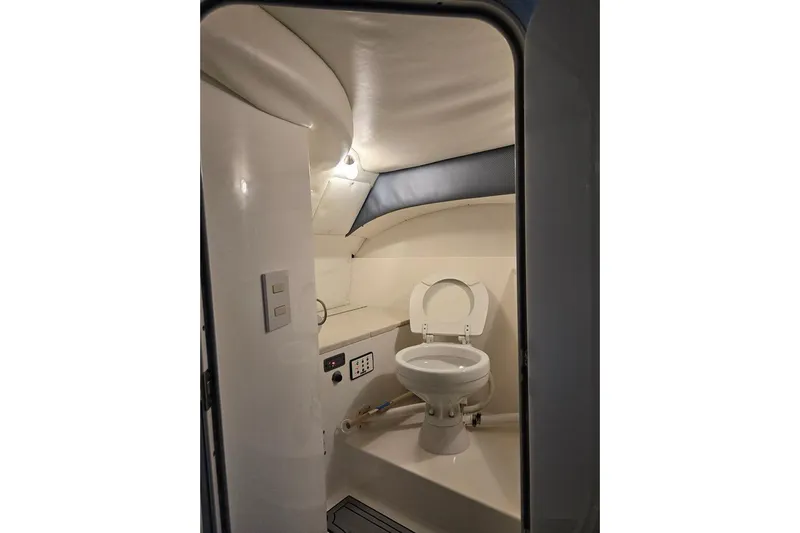  Yacht Photos Pics Interior of a 2007 Cobalt 343 boat bathroom with toilet and lighting.