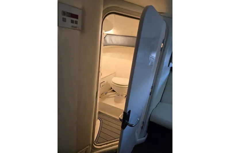  Yacht Photos Pics Interior view of a 2007 Cobalt 343 boat bathroom with open door.