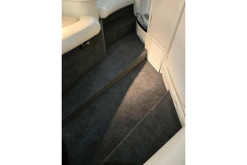  Yacht Photos Pics Interior of 2007 Cobalt 343 boat with carpeted steps and white seating.