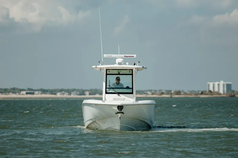  Yacht Photos Pics 2013 Boston Whaler 320 Outrage boat cruising on open water.