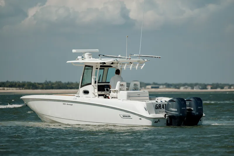  Yacht Photos Pics 2013 Boston Whaler 320 Outrage boat cruising on open water.